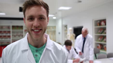 handsome medical student smiling at camera in class