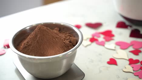 slow pan to bowl of cacao powder making a special valentine's day cake vegan chocolate cake eggless plant based dairy free