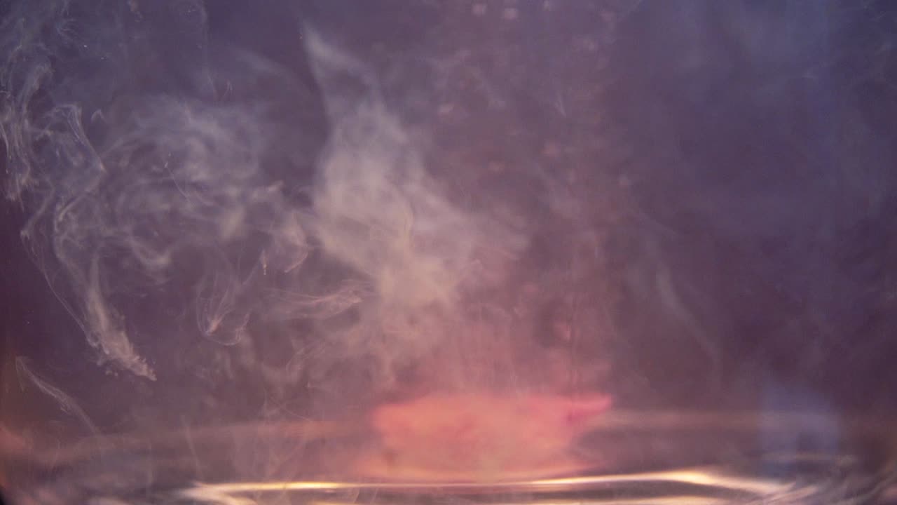 Slowmotion shot of efervescent pill dissolving in water. Bubbles going up. Stable shot with the Sony a7iii