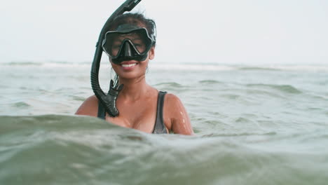 Woman-putting-diving-goggles-on