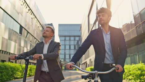 business managers holding scooter bicycle at downtown. corporate people commute