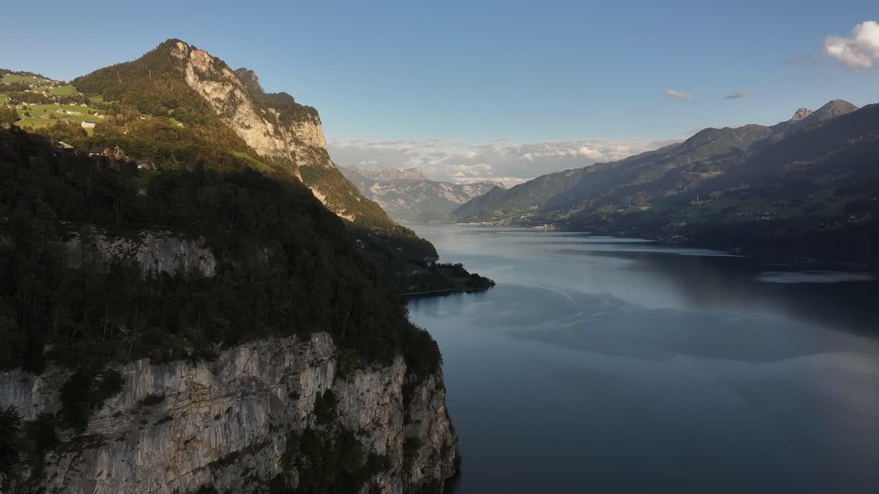 Aerial view of Walensee lake nestled beneath majestic mountain ranges in Wessen, Switzerland. Natural beauty showcasing serene landscapes and crystal-clear waters.