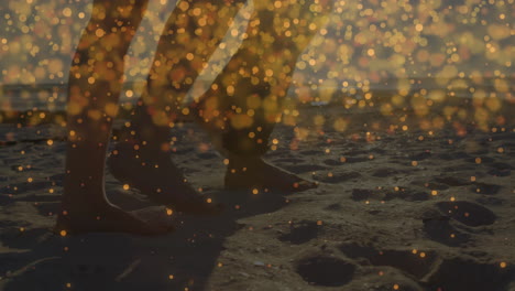 couple walking on wet beach sand at sunset, showcasing animated travel marketing icons and bokeh