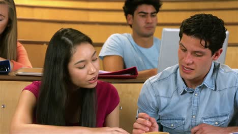 students sitting beside each other while learning