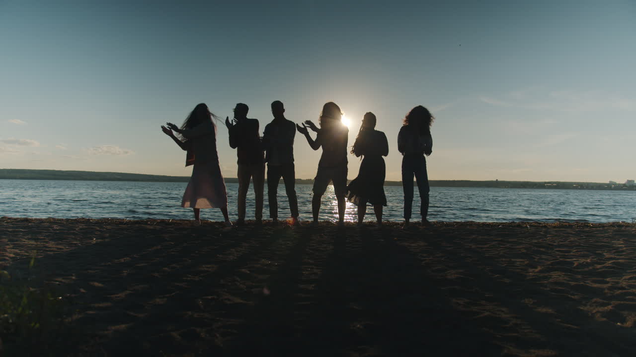Friends Dancing on the Beach at Sunset