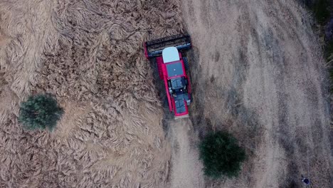 top view of thresher collecting wheat after the sunset