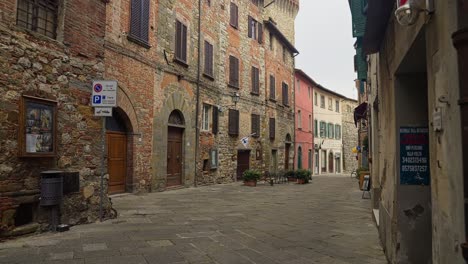 walking on the empty street of the medieval town of lucignano in the province of arezzo, italy