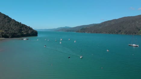 slowmo - aerial shot of sail boats by anakiwa in queen charlotte sound, marlborough sounds, south island, new zealand