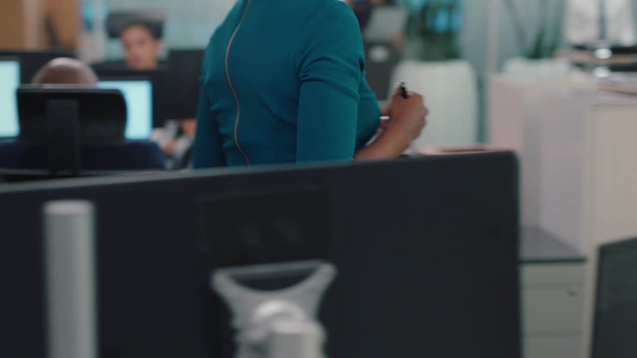 african american business woman working with colleague in busy office corporate sales team collaborating on financial project for company strategy