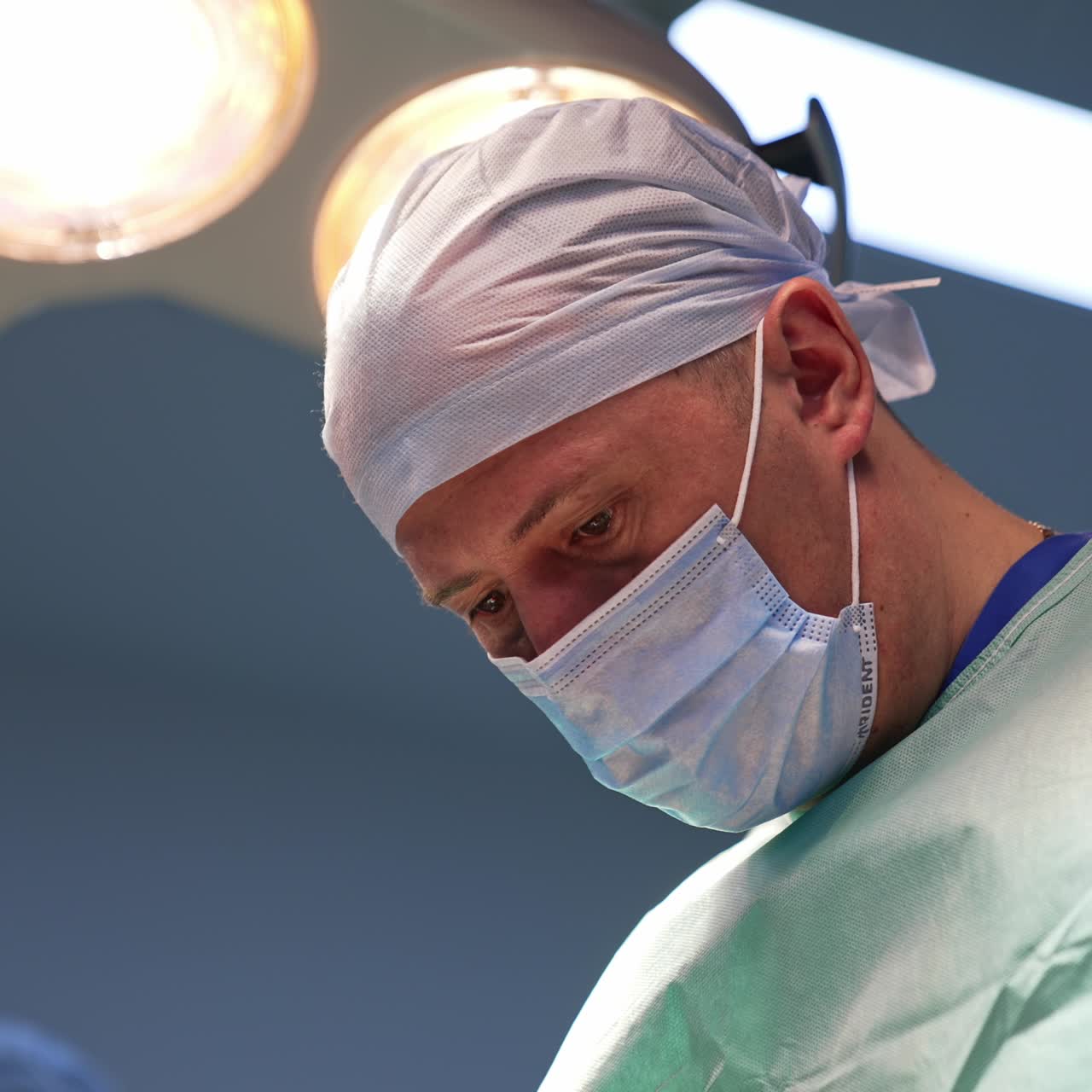 Plastic surgeon concentrated on the operation. Portrait of a professional doing his work in a modern clinics. Low angle view