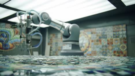 in an art studio, a robotic arm skillfully arranges colorful tiles to form detailed mosaic patterns. the backdrop features vibrant wall art enhancing the creative environment.
