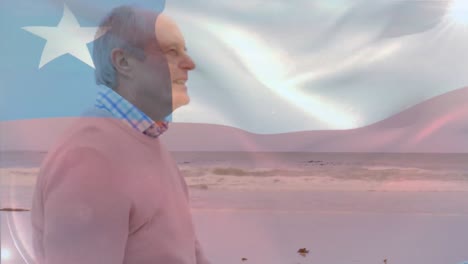 Animation-of-flag-of-chile-waving-over-senior-caucasian-man-looking-at-sea-while-standing-on-beach