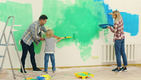family painting a wall together