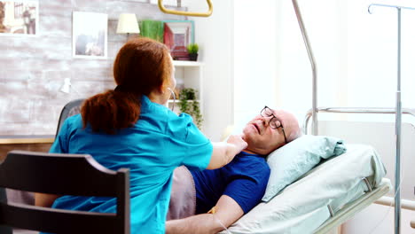 old sick man in a hospital bed gets his heartbeat checked