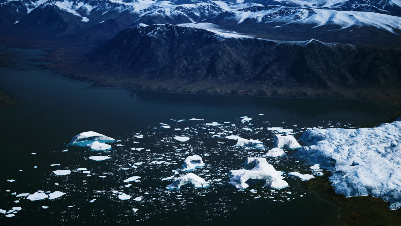 Icebergs floating in tranquil waters under a clear blue sky in greenland