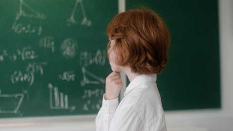 student looking at the chalkboard during math class.