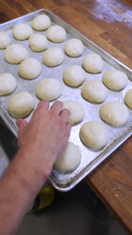 preparing dough rounds for baking