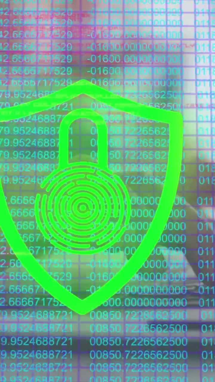 Animation of padlock in shield over numbers against cropped hands of caucasian woman using laptop