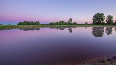 calm colorful sunrise reflections of the sky in a still water lake