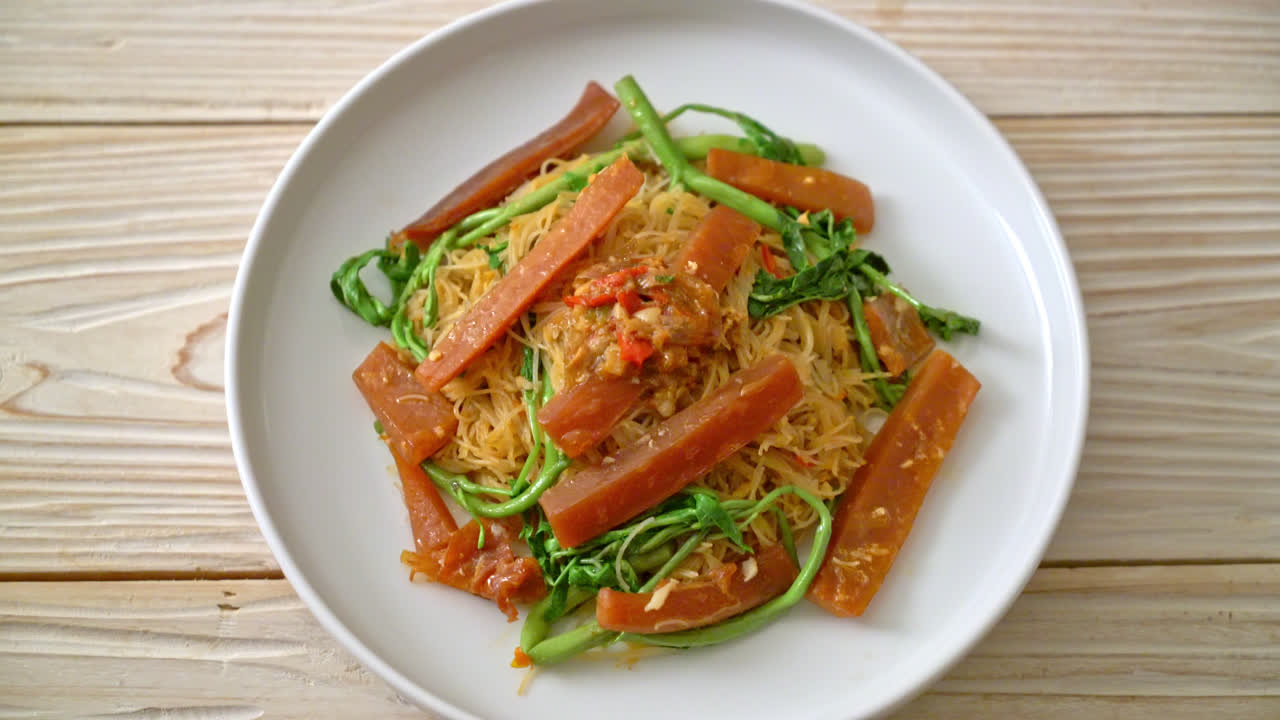 절인 오징어를 곁들인 볶음 쌀 당면과 물 미모사