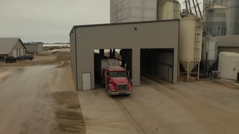 Drone-shot-of-a-semi-loading-feed-at-a-farm's-feed-mill-in-Minnesota