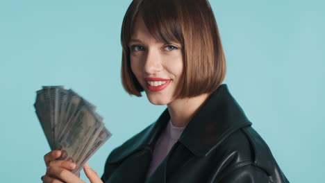 Happy-brunette-woman-holding-banknotes