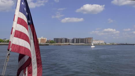 flag flying on ship over boston harbor