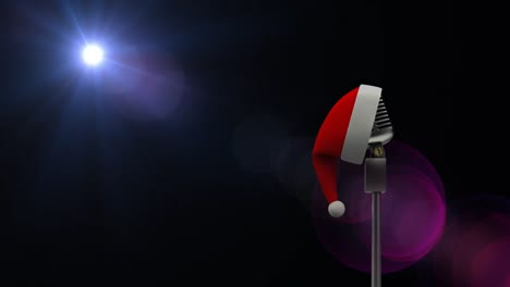 Animation-of-light-and-vintage-microphone-in-santa-hat-on-black-background