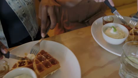 young adult female friends hanging out in a cafe