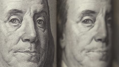 american dollars. portraits of franklin on one hundred dollar bills are moving in the frame. cash. money background. close-up