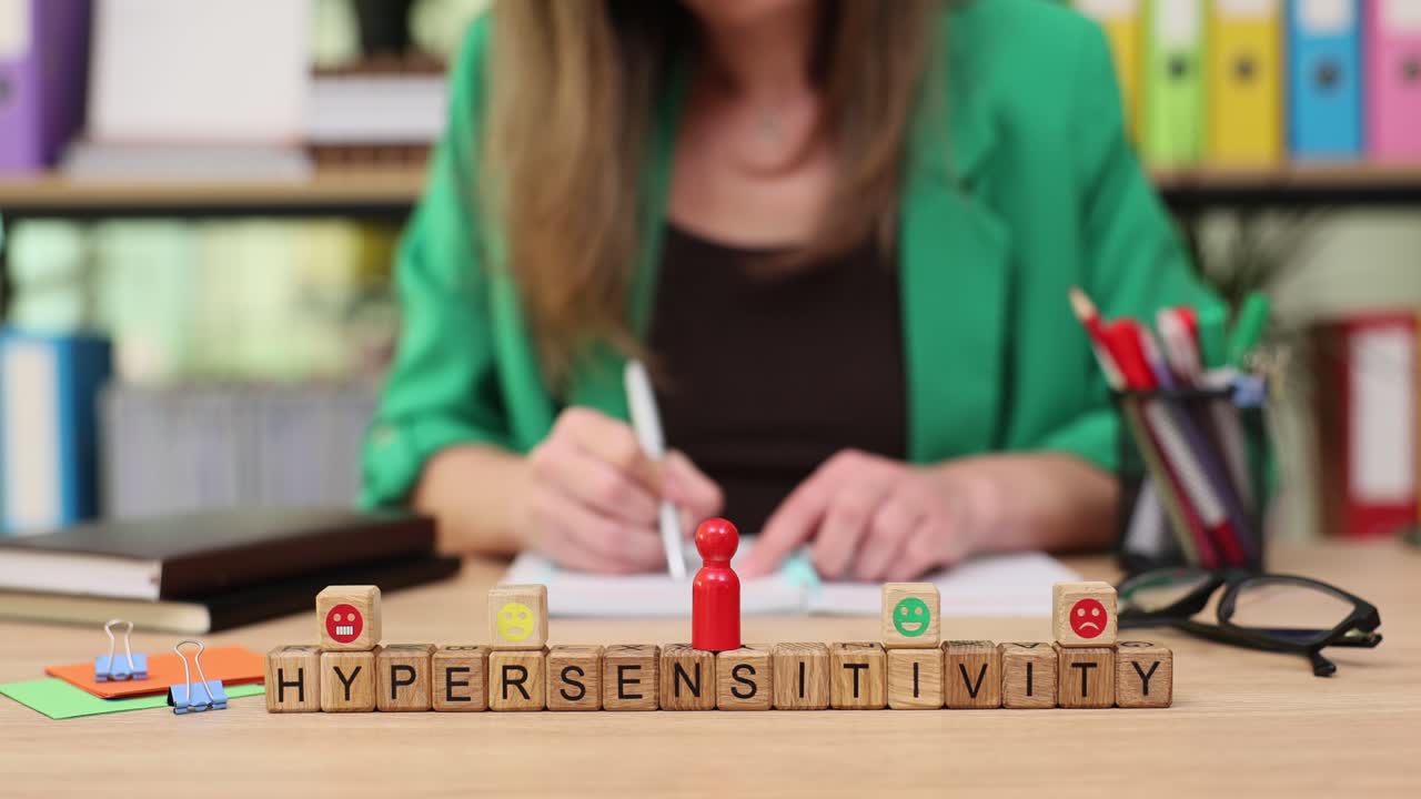 Hypersensitivity concept with wooden blocks and emojis