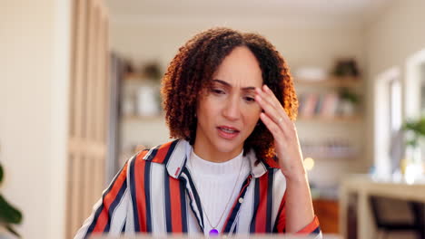 woman experiencing headache while working from home