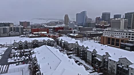 salt lake city utah skyline view on gloomy snow-covered day, aerial dolly