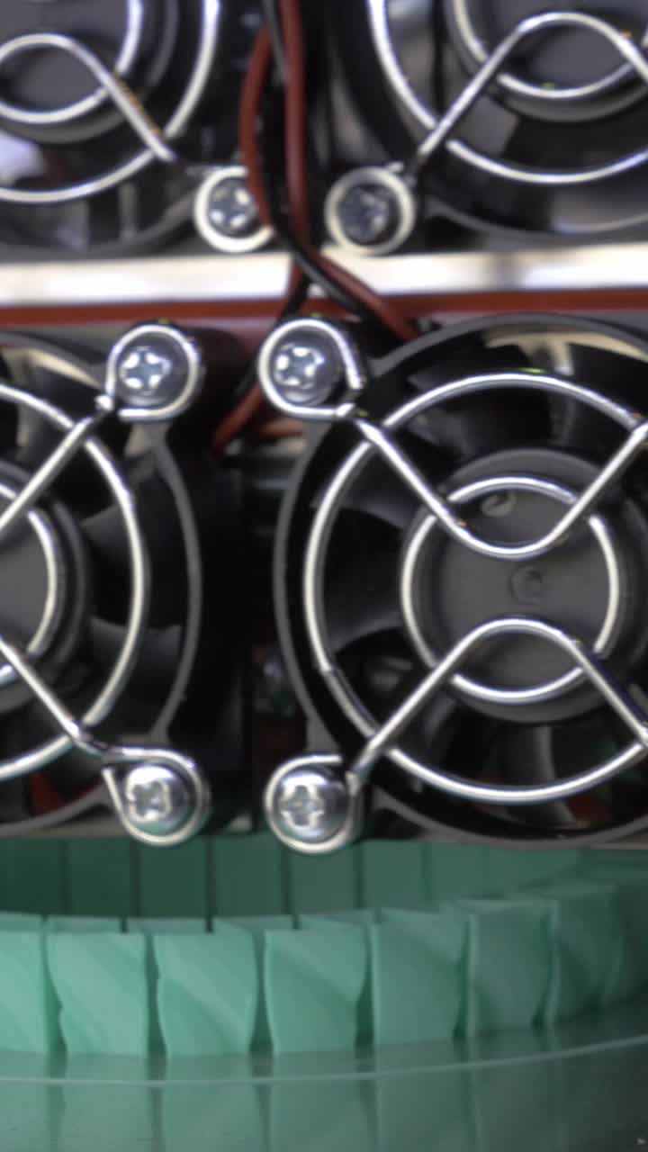 Close-up of a 3D Printer Manufacturing a Green Plastic Object