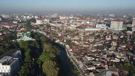 Aerial-view-of-downtown-Yogyakarta,-river,-buildings,-houses-and-small-streets-shot-in-the-morning