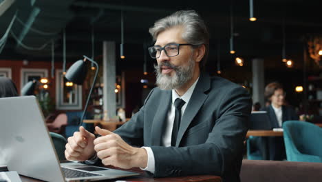 businessman working on laptop in cafe