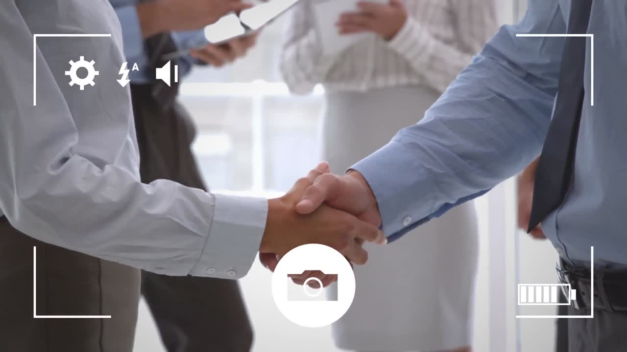 Taking photos of businessmen shaking hands on a digital camera