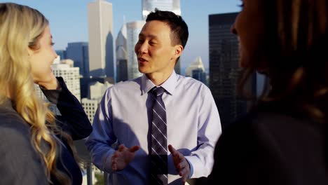 multi ethnic business people talking strategy overlooking chicago