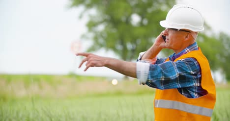 Engineer-Analyzing-Traffic-Polution-On-Clipboard-Amidst-Crops-At-Farm-9