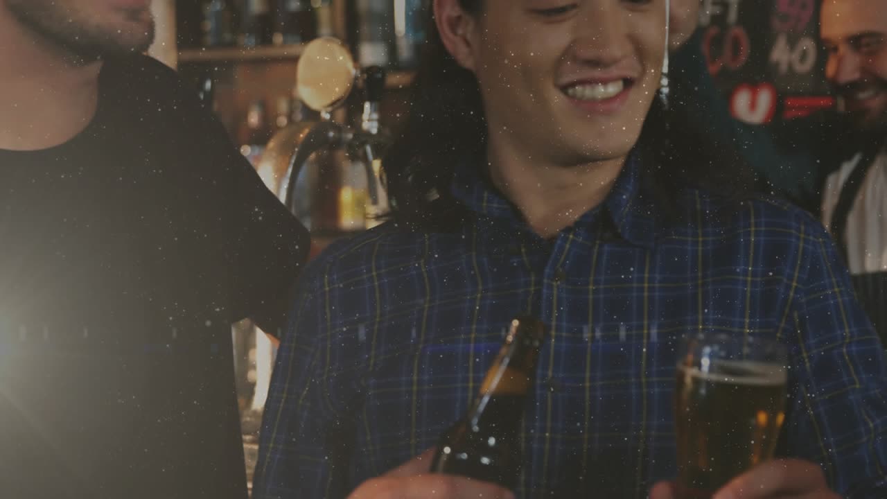 Central man in blue plaid shirt raising pint to start hospitality toast, friends' bottles clinking