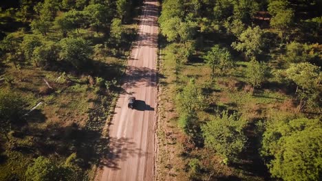 drone view of car travelling in the african landscape