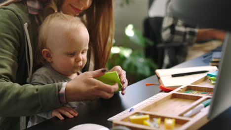 Office-employee,-mom-with-baby-and-woman-playing