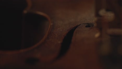 close up of old violin, dramatic light changes over the instrument , classical symphony music video footage