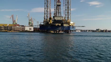 boat, passengers and crew passing the oil platform at shipyard uljanik in pula