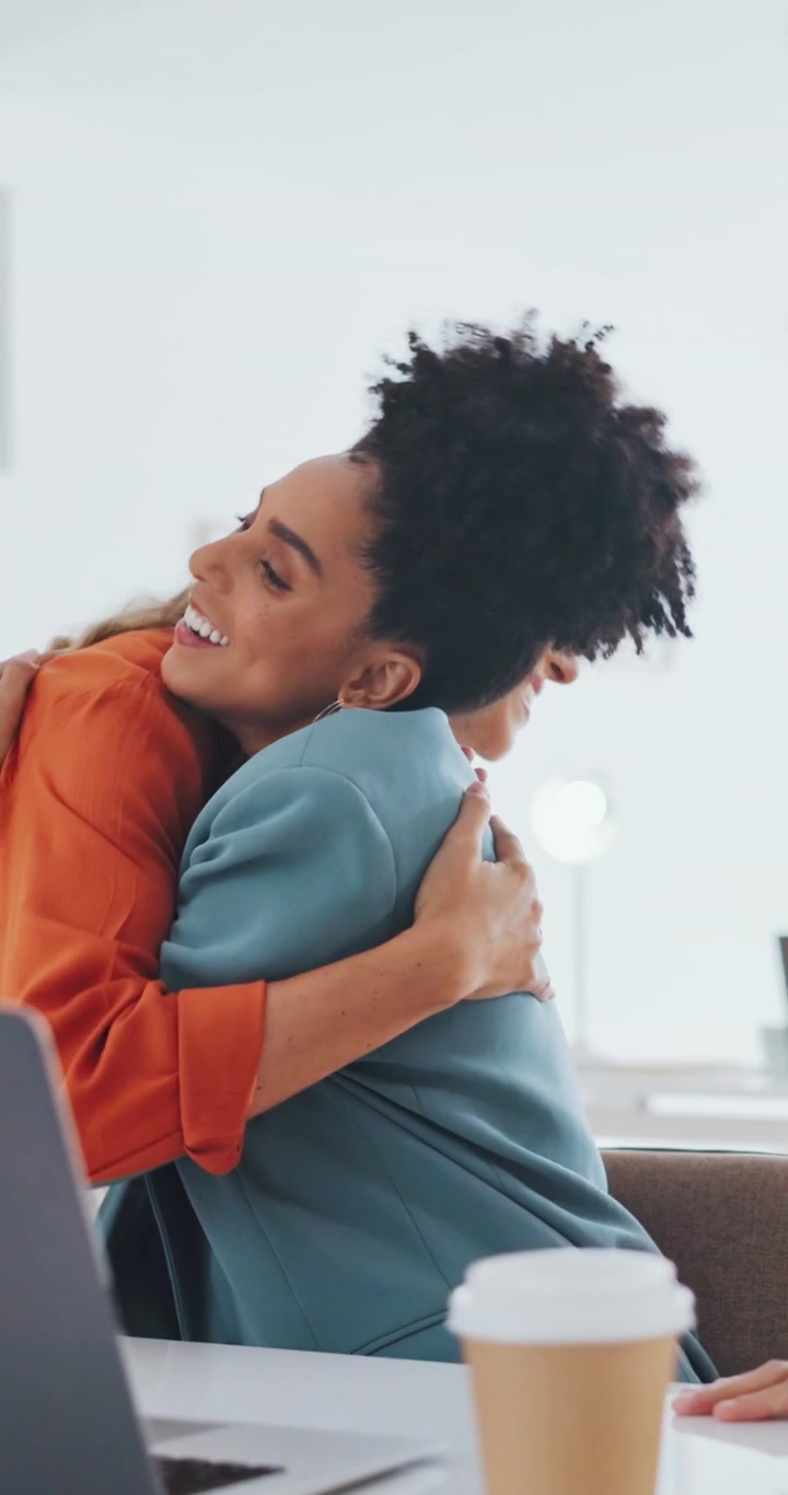 Two Excited Businesswomen Celebrating Success in Modern Office