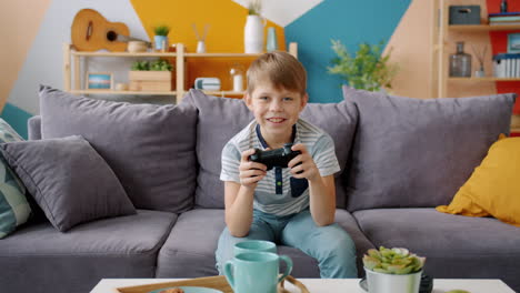 boy playing video games on a couch