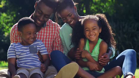 A-family-having-fun,-each-parents-tickling-a-child