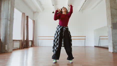 young woman dancing hip hop in a studio