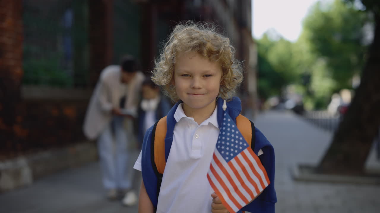 Young Boy Holding American Flag