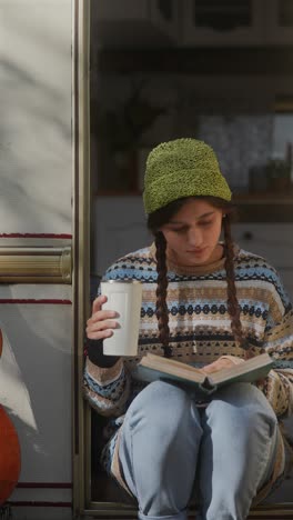 teenage girl reading a book in an rv